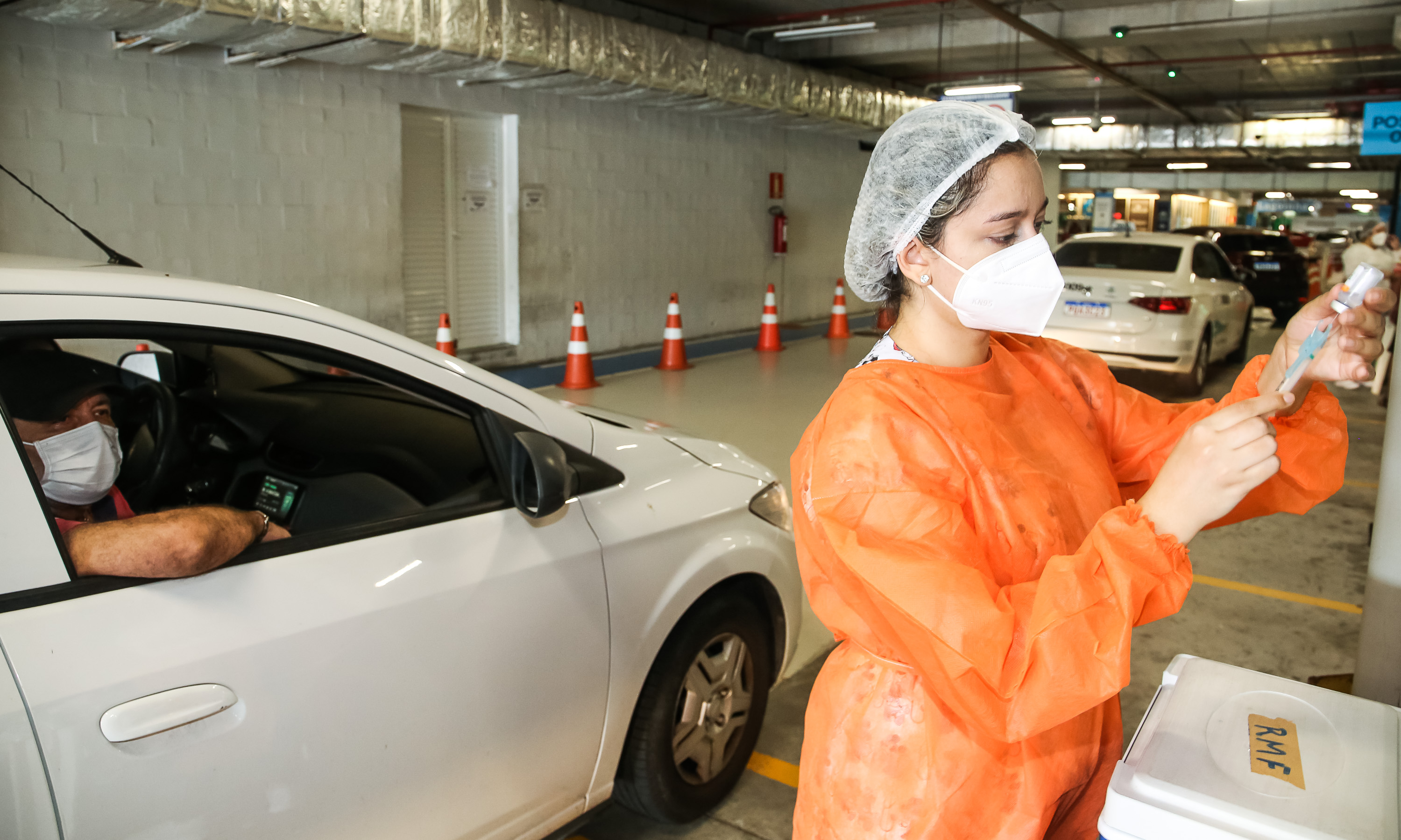 enfermeira ajusta uma seringa de vacinação